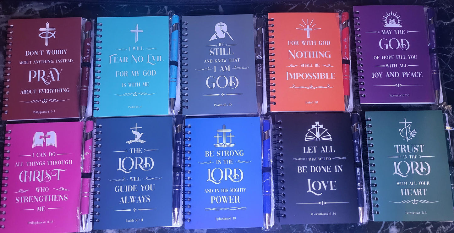 Colorful spiral notebooks with matching sturdy pens displaying Christian bible verses