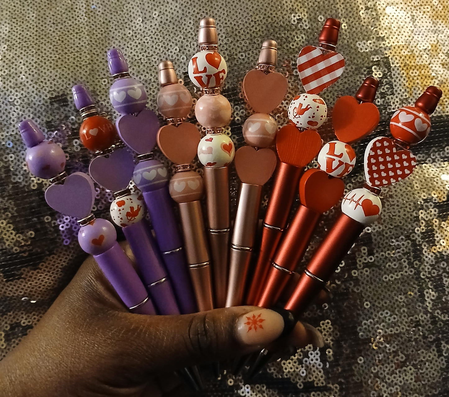 beautiful hand beaded pens in the red,purple and pink colors with wooden hearts, crystal beads and writes really well.