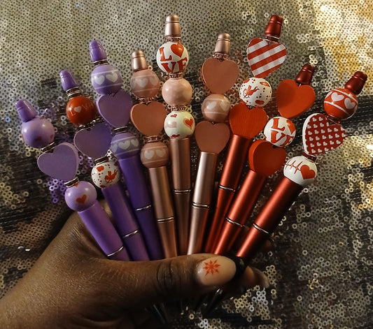 beautiful hand beaded pens in the red,purple and pink colors with wooden hearts, crystal beads and writes really well.